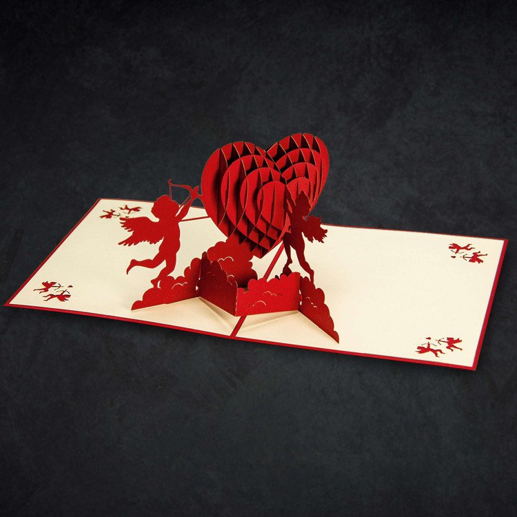 An open Cupid Couple Greeting Card with a pop-up heart inside