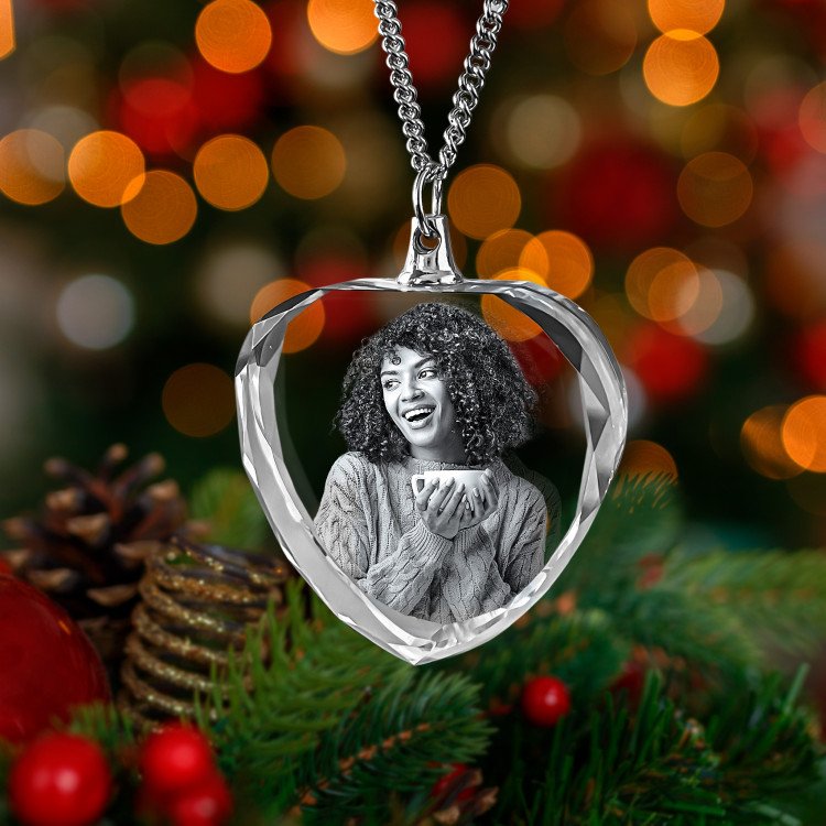 A 3D Necklace Heart showcasing an engraved photo of a happy girl with cap of tea